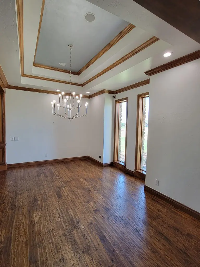 Freshly painted empty living room with hardwood floors and modern ceiling design in Oklahoma City