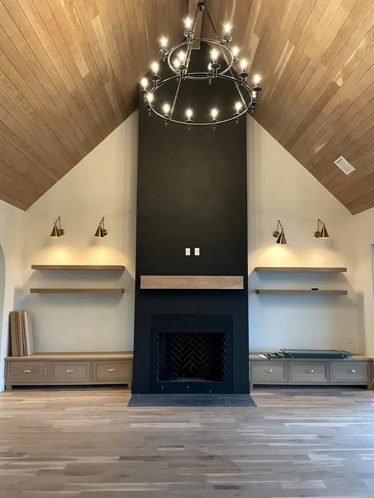 Modern living room with black accent fireplace and wood ceiling – Nichols Hills, OK