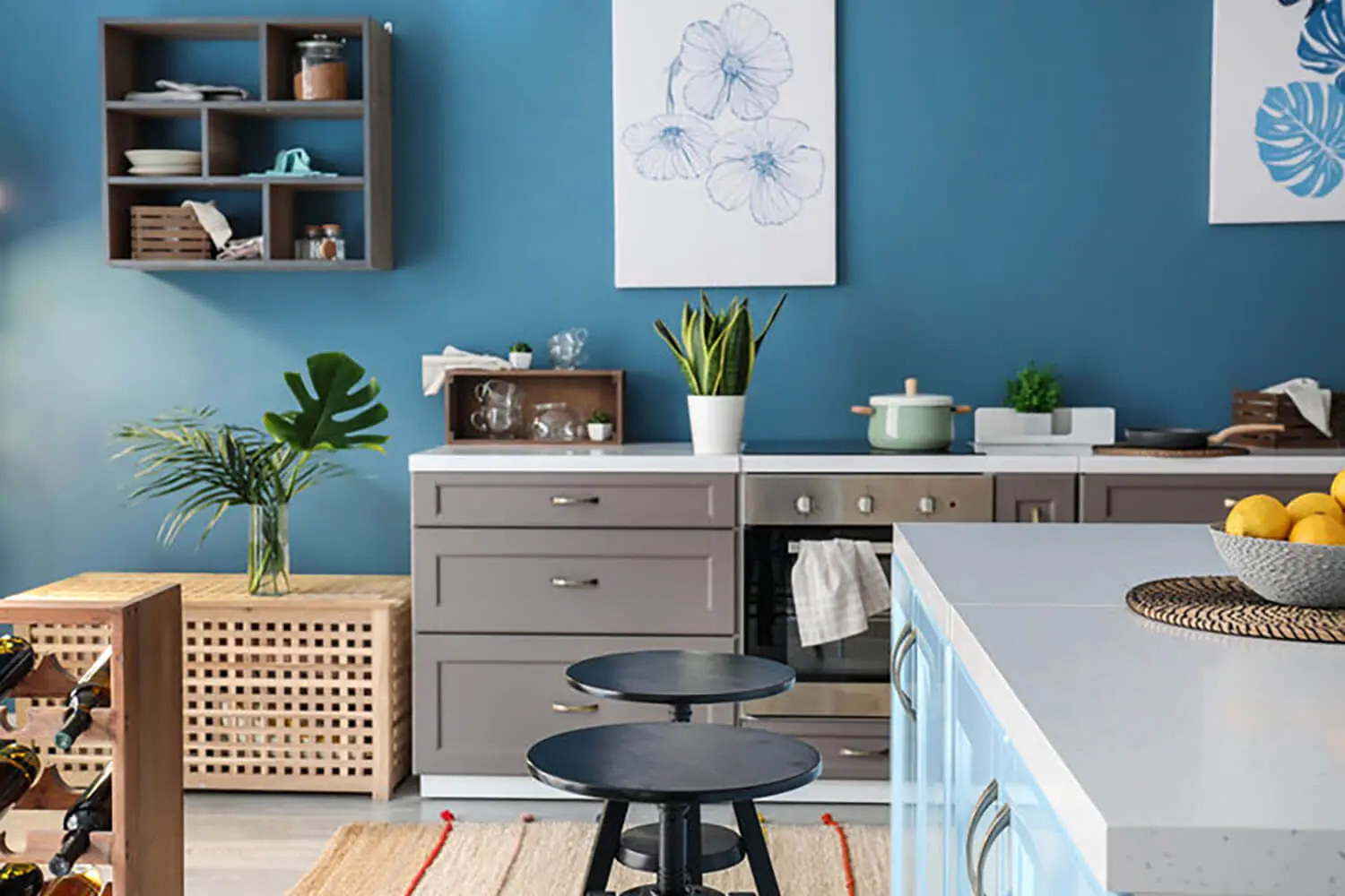 Modern kitchen with blue walls and clean surfaces, showing how to prepare your home for professional interior painting before painters arrive.