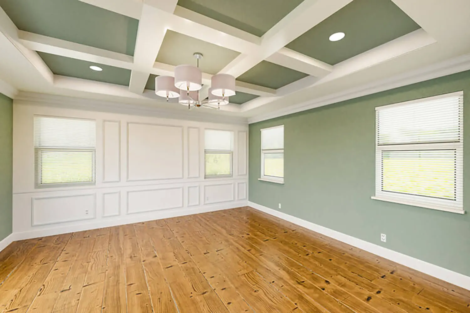 Freshly painted living room with green walls and white trim, showing how interior paint finish choice affects maintenance and durability in everyday spaces