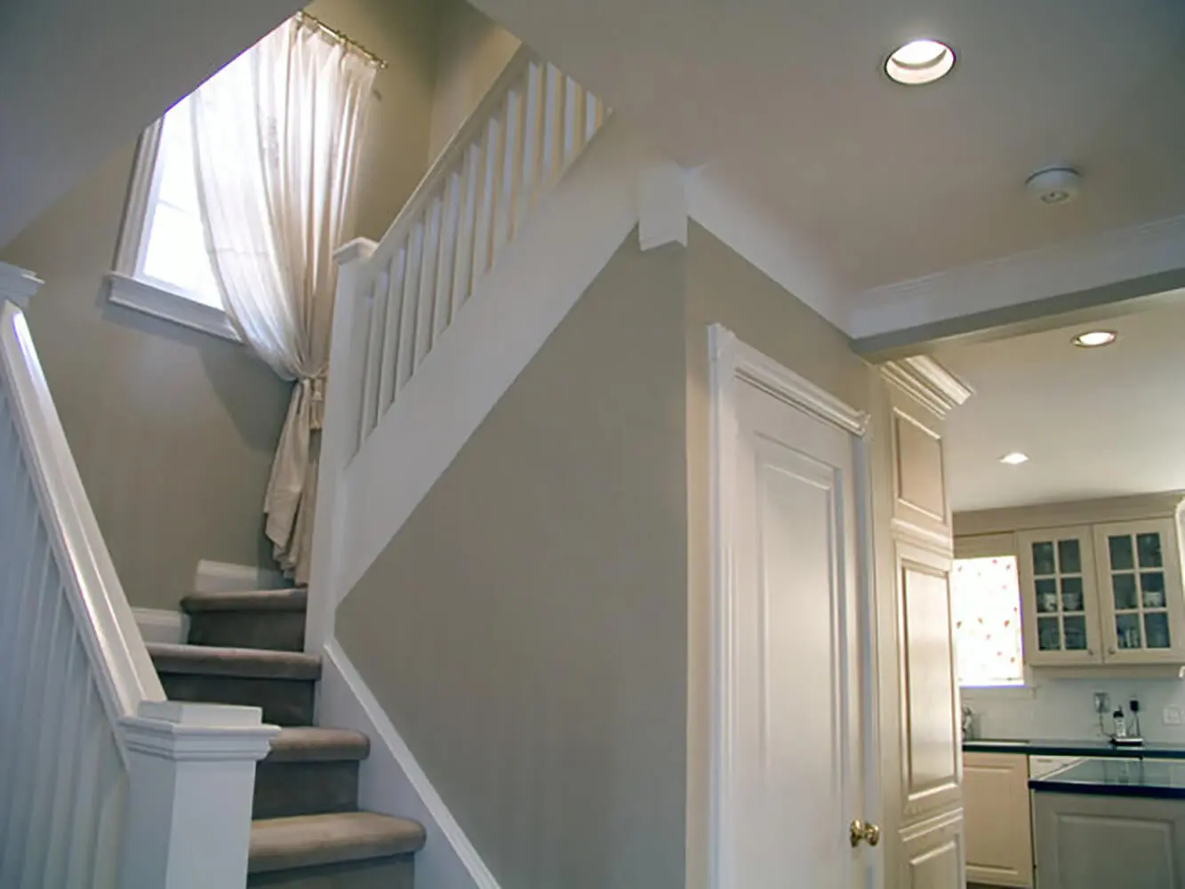Interior home staircase and walls prepared during painting project showing how professional painters protect your home during interior painting