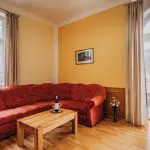 Interior painting for older homes with warm yellow walls, wood trim, and classic living room furnishings.