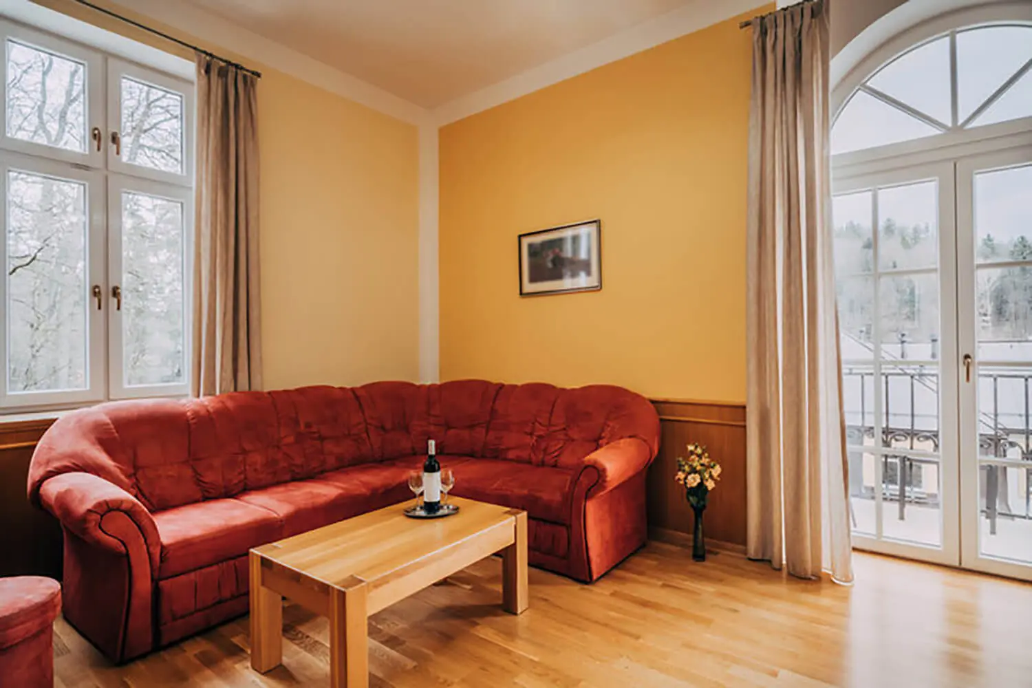 Interior painting for older homes with warm yellow walls, wood trim, and classic living room furnishings.