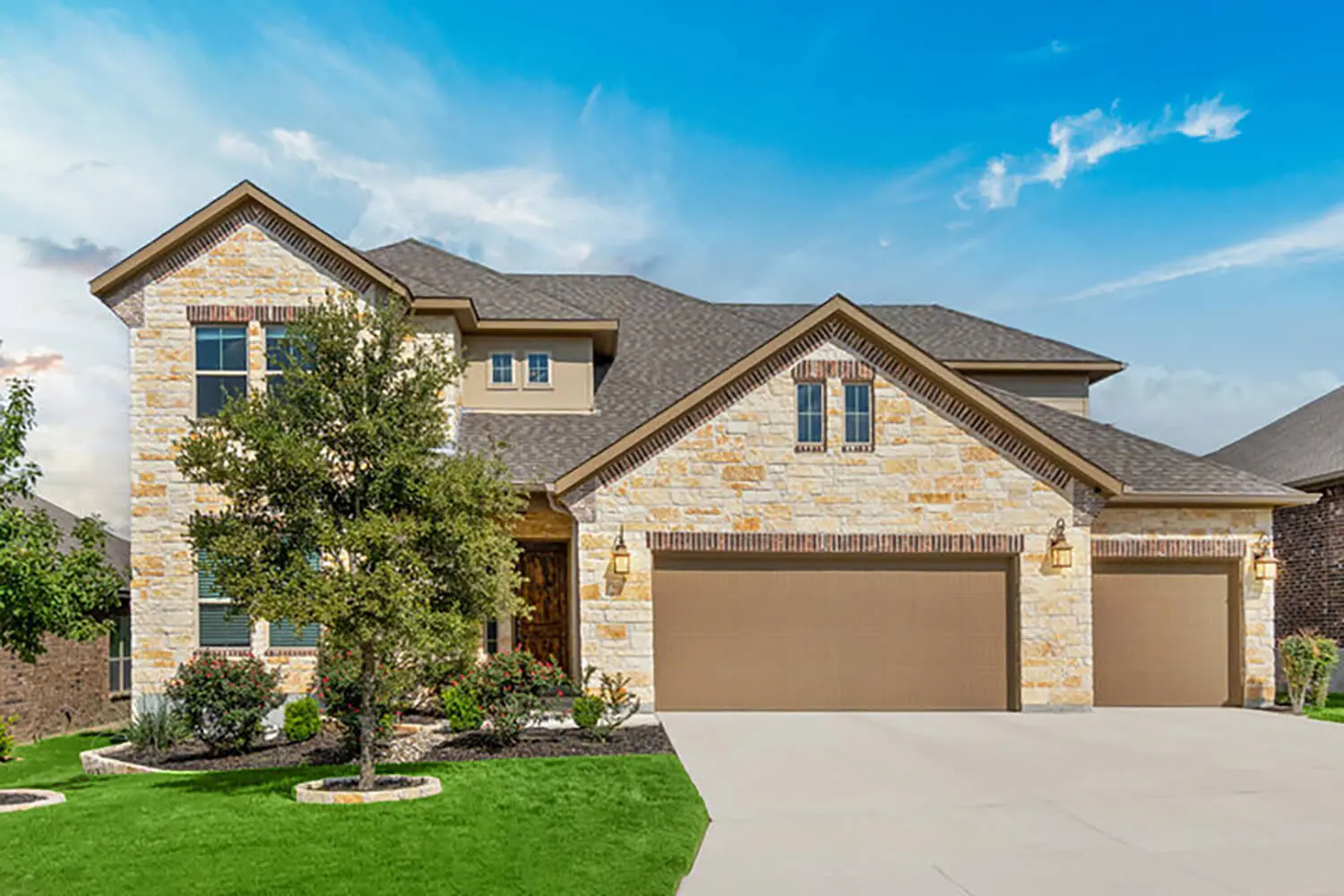 Two-story stone and stucco home exterior in Oklahoma City with a professionally painted finish.