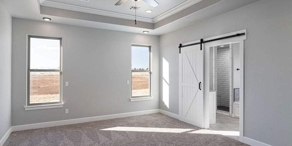 roller brush applying even coat of paint on interior wall