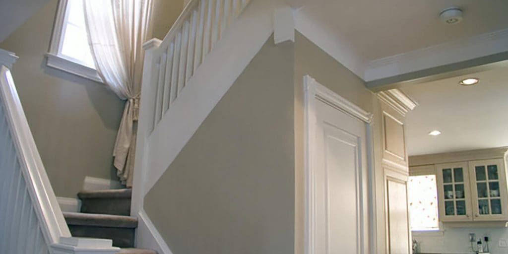 Interior home staircase and walls prepared during painting project showing how professional painters protect your home during interior painting