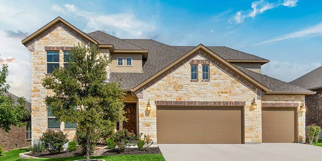 Two-story stone and stucco home exterior in Oklahoma City with a professionally painted finish.